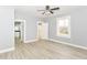 Bright bedroom featuring wood floors, a ceiling fan, and access to bath and kitchen at 209 Pennsylvania St, Shirley, IN 47384