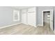 Bright bedroom with light-gray walls, wood-look floors, two closets, and an open doorway at 209 Pennsylvania St, Shirley, IN 47384