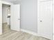 Bright bedroom with light-gray walls, wood-look floors, and open doorways at 209 Pennsylvania St, Shirley, IN 47384