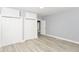 Bright bedroom with light-gray walls, wood-look floors, two closets, and an open doorway at 209 Pennsylvania St, Shirley, IN 47384
