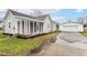 Quaint gray home with a detached garage and long driveway at 209 Pennsylvania St, Shirley, IN 47384