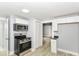 Compact kitchen with stainless steel appliances and access to living spaces at 209 Pennsylvania St, Shirley, IN 47384