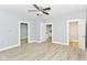 Inviting living room with hardwood floors, ceiling fan, and neutral paint at 209 Pennsylvania St, Shirley, IN 47384