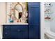 Charming bathroom with blue vanity, gold hardware, and ornate mirror at 20971 Shoreline Ct # 309, Noblesville, IN 46062