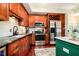 Well-lit kitchen featuring stainless steel appliances, tile backsplash, and dark wood cabinets at 20971 Shoreline Ct # 309, Noblesville, IN 46062