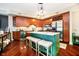 Kitchen with island, hardwood flooring, stainless steel appliances, and stylish pendant lighting at 20971 Shoreline Ct # 309, Noblesville, IN 46062