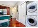 Hallway view featuring in-unit laundry with modern washer and dryer and hardwood floors at 20971 Shoreline Ct # 309, Noblesville, IN 46062