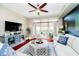 Living room featuring a ceiling fan, a sliding glass door to a balcony, and modern decor at 20971 Shoreline Ct # 309, Noblesville, IN 46062