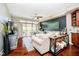 Sunlit living room boasts hardwood floors, a ceiling fan, and a sliding glass door to the balcony at 20971 Shoreline Ct # 309, Noblesville, IN 46062