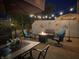 Inviting backyard patio features a fire pit, stylish seating, string lights and decorative wall art creating a cozy outdoor space at 20971 Shoreline Ct # Apt 212, Noblesville, IN 46062