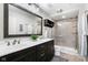 Modern bathroom features a double sink vanity, large mirror, and a glass-enclosed shower with neutral tile at 20971 Shoreline Ct # Apt 212, Noblesville, IN 46062