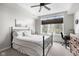 Bright bedroom with a large window, features a comfortable bed, ceiling fan, and stylish décor at 20971 Shoreline Ct # Apt 212, Noblesville, IN 46062