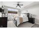 Bedroom with dark wooden bed frame, ceiling fan and natural lighting from large window at 20971 Shoreline Ct # Apt 212, Noblesville, IN 46062