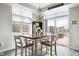 Bright dining area with modern chandelier and access to an outdoor balcony space at 20971 Shoreline Ct # Apt 212, Noblesville, IN 46062