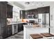 Modern kitchen with dark cabinets, stainless steel appliances, and a marble countertop island at 20971 Shoreline Ct # Apt 212, Noblesville, IN 46062