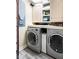 Well-organized laundry room with modern washer and dryer, cabinets, and ample counter space at 20971 Shoreline Ct # Apt 212, Noblesville, IN 46062