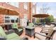 Outdoor patio with seating and dining options with an umbrella and string lights at 20971 Shoreline Ct # Apt 212, Noblesville, IN 46062