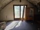 Attic space featuring a door to a balcony area, an electrical outlet, and interesting wooden furniture at 21977 Craig Ave, Noblesville, IN 46060