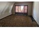 A bedroom with a window, an angled wall, and brown carpeting at 21977 Craig Ave, Noblesville, IN 46060