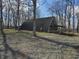 Unique home with a Quonset hut style design, surrounded by trees, providing a rustic charm at 21977 Craig Ave, Noblesville, IN 46060