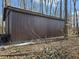 Exterior view of an outbuilding with metal siding in wooded area at 21977 Craig Ave, Noblesville, IN 46060