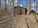 An exterior shot of outbuilding amongst trees and fallen leaves at 21977 Craig Ave, Noblesville, IN 46060