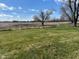 Picture of a nice sized back yard with partial fence-line and view of cultivated farm land at 2309 Dover St, Anderson, IN 46013