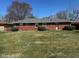 Back yard with brick exterior, level lot and medium trees. A great entertaining space! at 2309 Dover St, Anderson, IN 46013