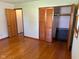 Bedroom features hardwood flooring, natural light, and closet storage at 2309 Dover St, Anderson, IN 46013