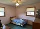 Small bedroom with wood floors, and classic windows provide natural light at 2309 Dover St, Anderson, IN 46013