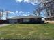 Charming brick home featuring a lush green lawn, concrete driveway, and an attached one-car garage at 2309 Dover St, Anderson, IN 46013