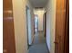 Straight hallway with carpeted floors and neutral colored walls at 2309 Dover St, Anderson, IN 46013