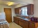 Traditional kitchen with wood cabinets, laminate counters, and a stainless steel double sink at 2309 Dover St, Anderson, IN 46013