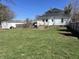 Spacious backyard view of home, green grass, shed and fencing at 238 S Main St, Wilkinson, IN 46186