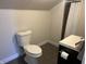 A functional bathroom with a toilet, sink, and shower with a curtain at 238 S Main St, Wilkinson, IN 46186