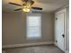 Bright bedroom offers a ceiling fan and natural light through the window at 238 S Main St, Wilkinson, IN 46186
