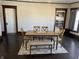 Comfortable dining room with wooden table, chairs, bench and hardwood floors at 238 S Main St, Wilkinson, IN 46186