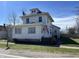 Charming two-story home with a traditional design and an American flag waving on the porch at 238 S Main St, Wilkinson, IN 46186