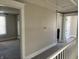 A carpeted hallway with doorways that lead into other rooms at 238 S Main St, Wilkinson, IN 46186