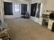 Spacious carpeted living room features ample natural light and a blue upholstered chair at 238 S Main St, Wilkinson, IN 46186