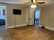 Bright living room with wood floors, a ceiling fan and views into other rooms at 238 S Main St, Wilkinson, IN 46186