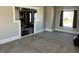 Cozy living room with gray walls, plush carpeting, and lots of natural light at 238 S Main St, Wilkinson, IN 46186
