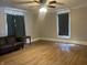 The living room offers wood flooring and a leather couch at 238 S Main St, Wilkinson, IN 46186