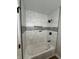Modern bathroom with white marble-like tile, black hardware, and built-in shower niche at 240 E Caven E St, Indianapolis, IN 46225