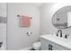 Stylish bathroom featuring new fixtures, a round mirror, and new sink at 240 E Caven E St, Indianapolis, IN 46225