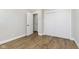 Spacious bedroom with wood-look flooring, closet, and lots of natural light at 240 E Caven E St, Indianapolis, IN 46225
