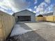 Detached garage with newly poured pad and fenced in yard under bright blue sky at 240 E Caven E St, Indianapolis, IN 46225