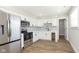 Modern kitchen featuring stainless steel appliances, white cabinets, and a contrasting backsplash for a stylish design at 240 E Caven E St, Indianapolis, IN 46225