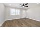 Open-concept living space with hardwood floors, a bright window, and a contemporary ceiling fan at 240 E Caven E St, Indianapolis, IN 46225