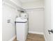 Utility room featuring water softener and water heater with convenient overhead shelving at 240 E Caven E St, Indianapolis, IN 46225